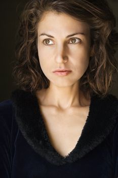 Head and shoulder portrait of pretty brunette woman.