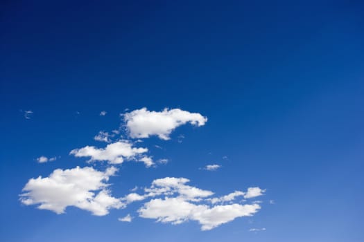 Cumulus clouds in blue sky.