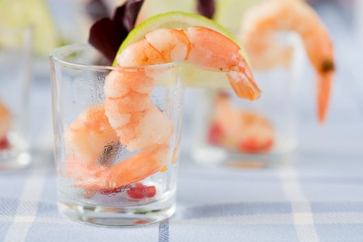 Delicious shrimp in small cocktailglass with lemon