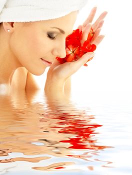 lovely woman with red flower petals in water