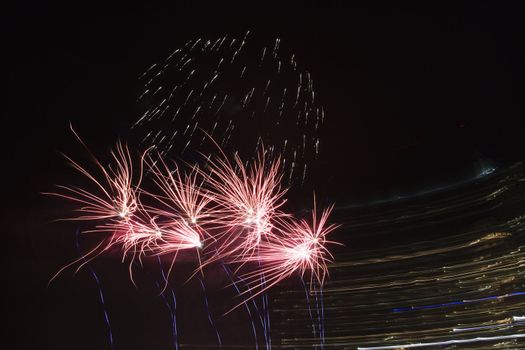 Colorful fireworks exploding in night sky.