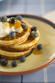 Delicious pancakes with ricotta, blueberries and honey