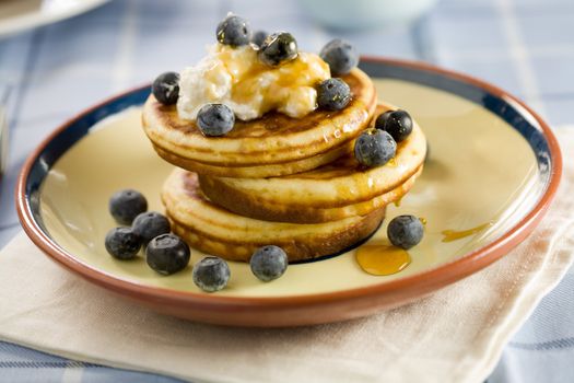 Blueberry pancakes with cream and honey