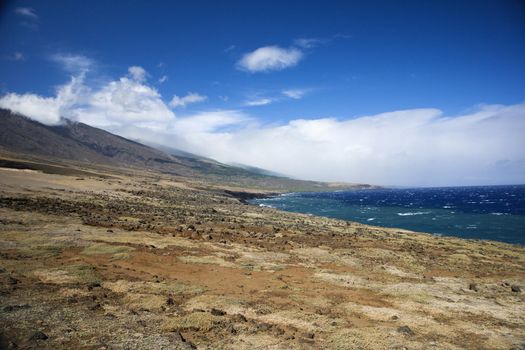 Barren landscape leading to Pacific ocean in Maui, Hawaii.