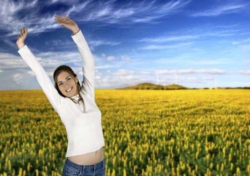 Beautiful young woman on a green landscape