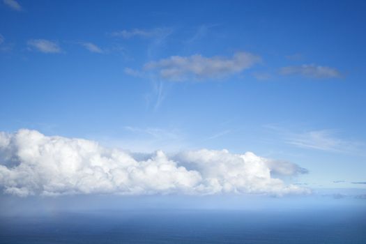 Blue sky with white puffy clouds.