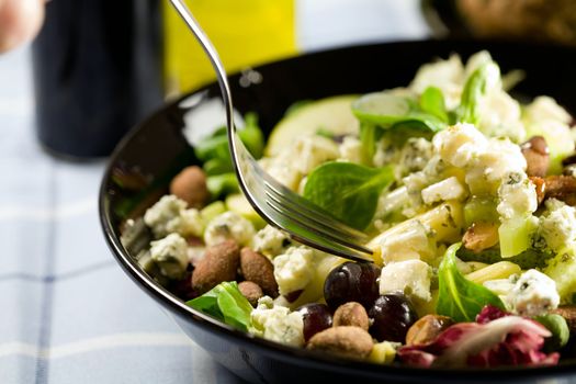 Delicious salad with cheese, grapes, pasta, pear and blue cheese