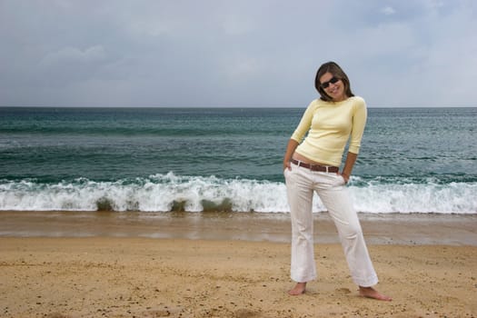 Beautiful woman posing in the beach 