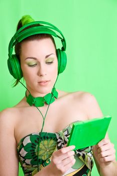 Pretty brunette wearing headphones and checking her cd-box