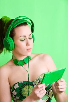 Pretty brunette on green background with headphones