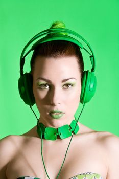 Beautiful brunette with bright green earphones on her head
