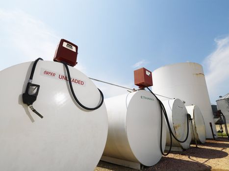 Fuel tanks labeled unleaded and ethanol and pumps.