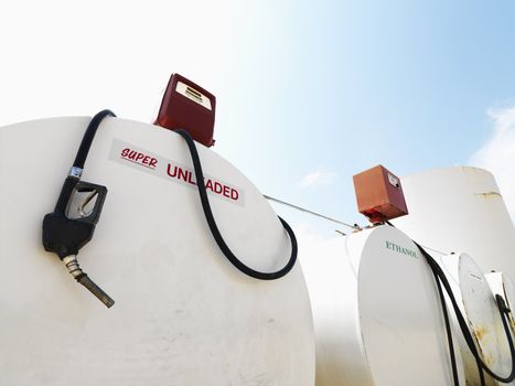 Fuel tanks labeled unleaded and ethanol and pumps.