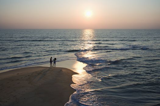 Aerial view of couple on beach in Bald Head Island, North Carolina during sunset.