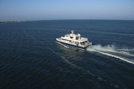 Aerial view of passenger ferry boat in open water near Bald Head Island, North Carolina.