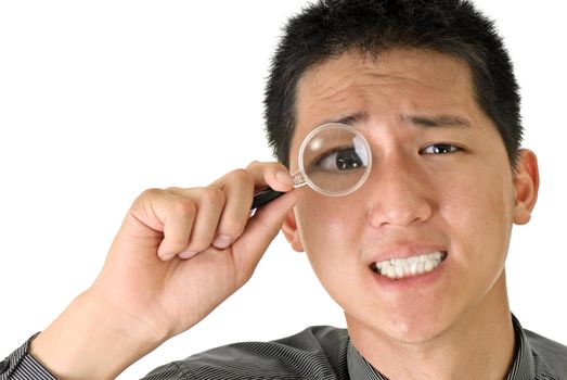 Business man with magnifier on eye, closeup portrait of Asian on white background.