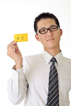 Asian business man holding yellow card written Chinese words on white background.