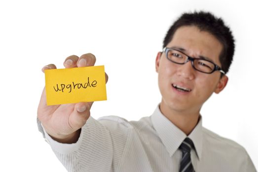 Business man want to upgrade and holding yellow card on white background.