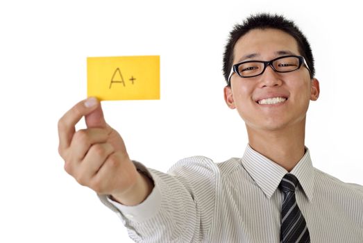 Happy business man holding A+ yellow card and smiling, closeup portrait focus on face against white background.