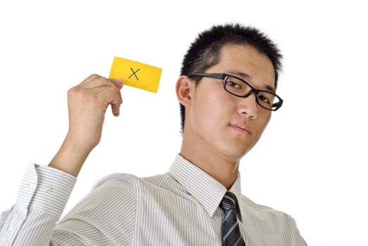 X sign on yellow card holding by business man, closeup portrait of Asian on white background.