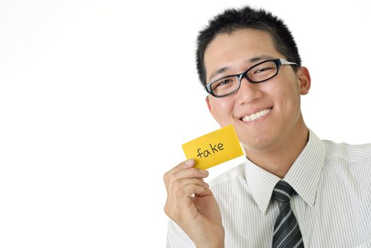 Smiling business man holding fake words card on white background.