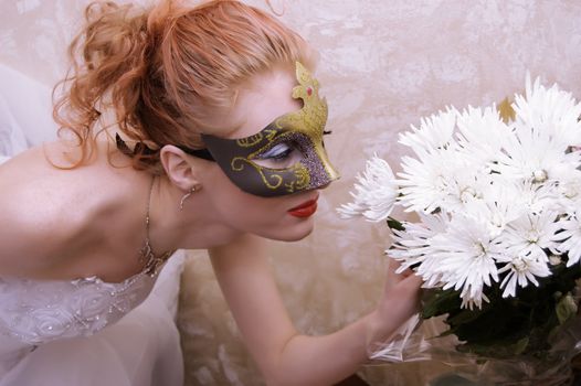 mysterious woman in mask holding white flowers