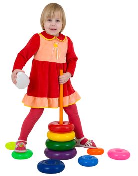 Small girl and toy plastic pyramid on white