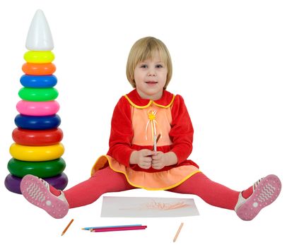 Little girl and toy pyramid and crayons on white