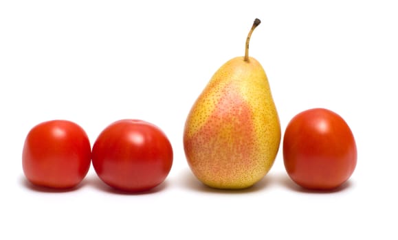 Three red tomatoes and pear on a white background.