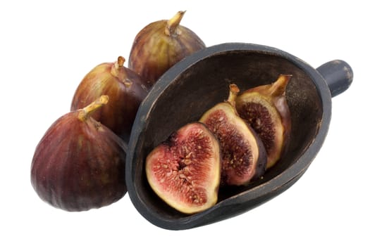 fresh Turkish figs with a rustic, wooden scoop, isolated on white, whole fruits and cross sections