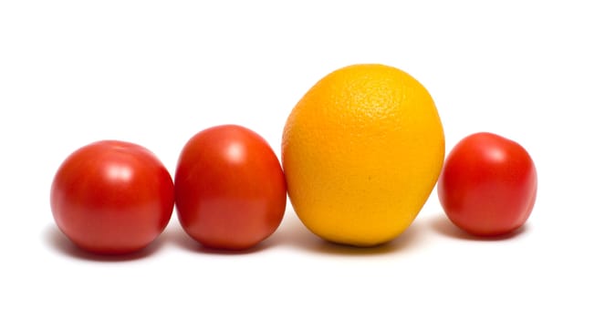 Three red tomatoes and yellow orange on a white background.