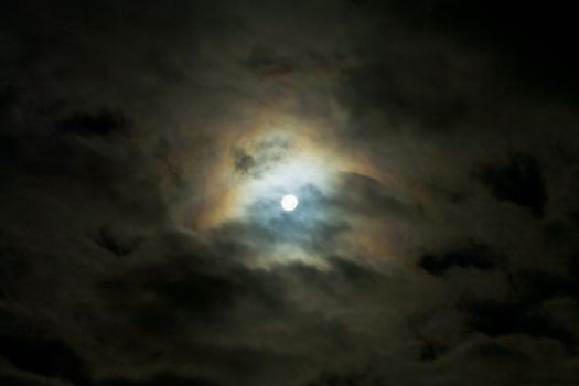 Bright moon on night sky in the middle clouds