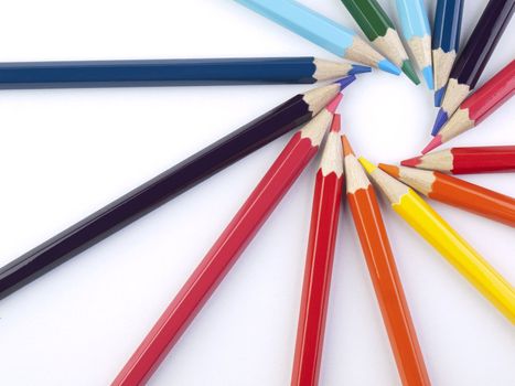 A circle formed by the points of several colored pencils.