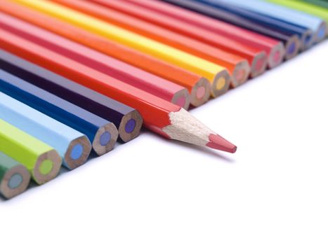 A red pencil comes out from the row of color pencils.