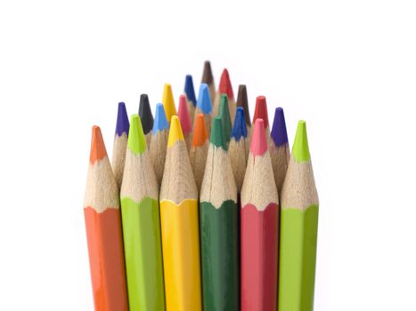 Several colored pencils stand together forming a triangle shape.