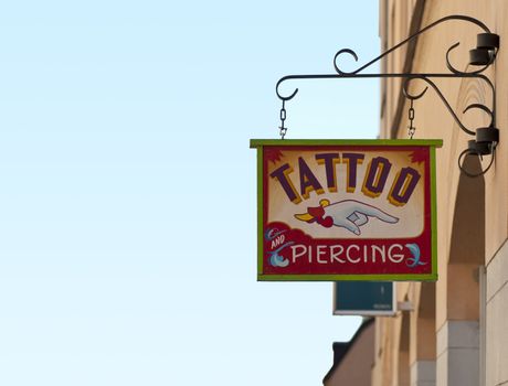 Tattoo and piercing sign outside tattoo parlor