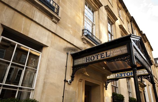 Hotel sign over the entrance to an old stone building