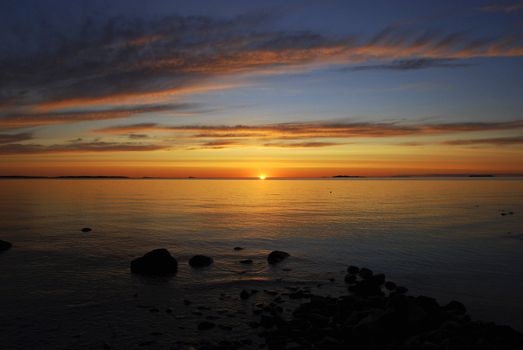 The sun setting over a lake in central sweden