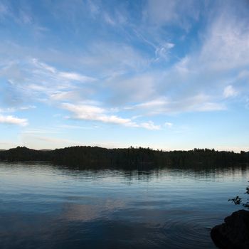 A view of lower Saranac Lake and islands located in the upstate New York Adirondacks around dusk.