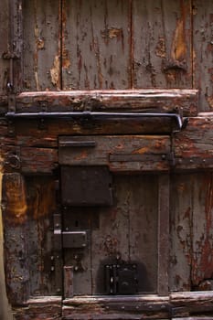 Old wood door with a series of antique metal locks
