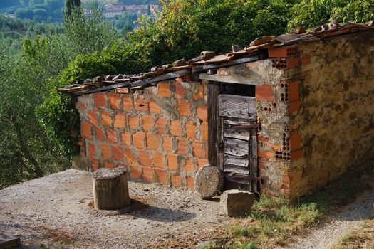 Rustic brick shed with torn down wooden door