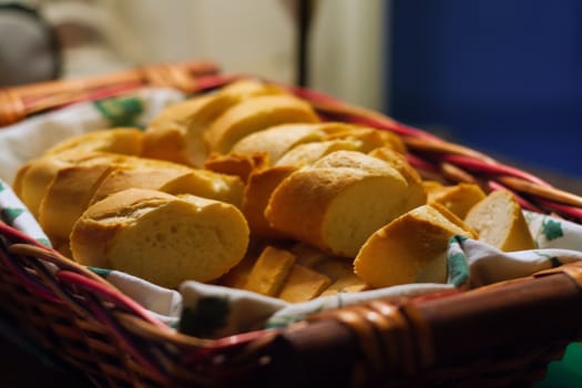 Basket of sliced bread with piece of cloth in the basket