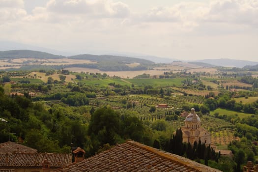 Roofs and dome foreground, hills and fields of Tuscany in the background