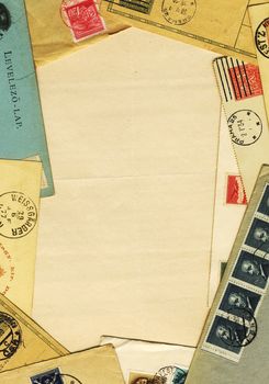 grungg Paper framed by vintage postcards and envelopes