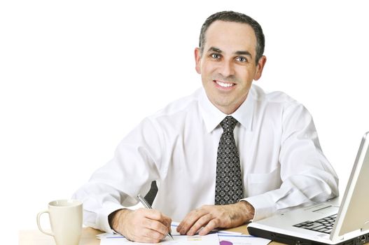 Happy office worker reviewing generic reports at his desk