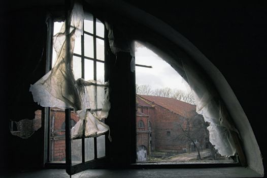 A view through a window in an abandoned house.
