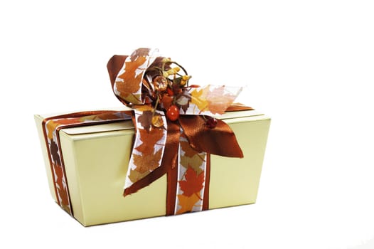 A gold decorated box of chocolates set on a white isolated background.