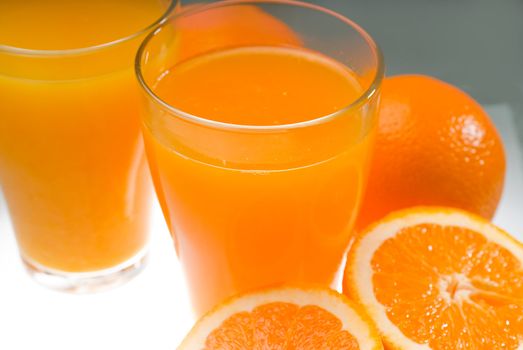 fresh and healthy orange juice ,unfiltered ,over a light table