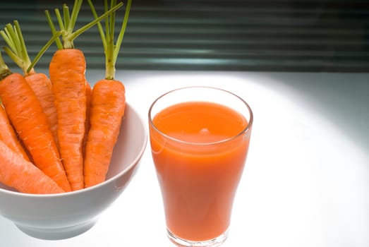 fresh and healty carrot juice unfiltered over a light table