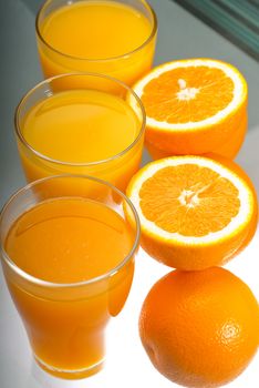 fresh and healthy orange juice ,unfiltered ,over a light table